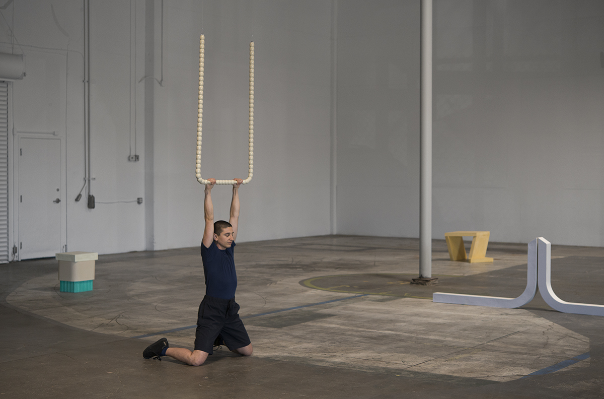 Gordon Hall, [em] THROUGH AND THROUGH AND THROUGH [/em], Portland Institute for Contemporary Art [br] performance still with Turned Hanging Bar (Beige), Laquered cast concrete, 2019