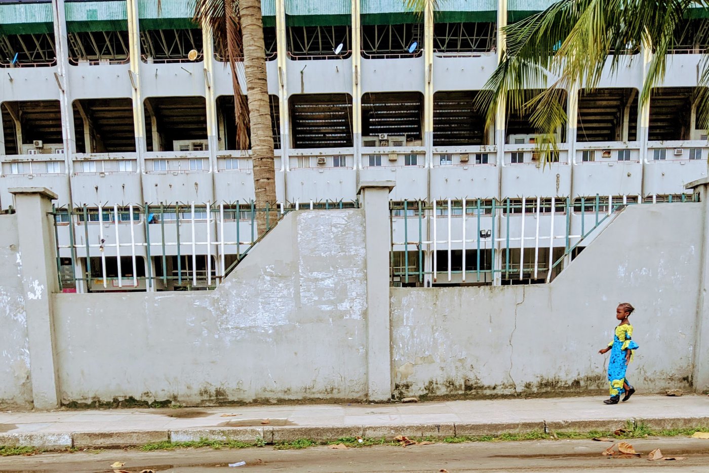 A young girl walks along a street in Lagos.