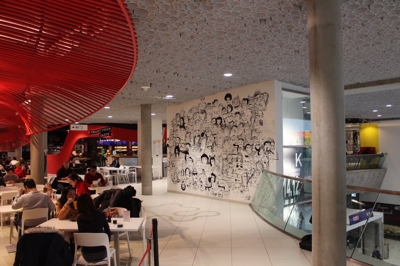 People sit next to the art wall at Ramien's restaurant