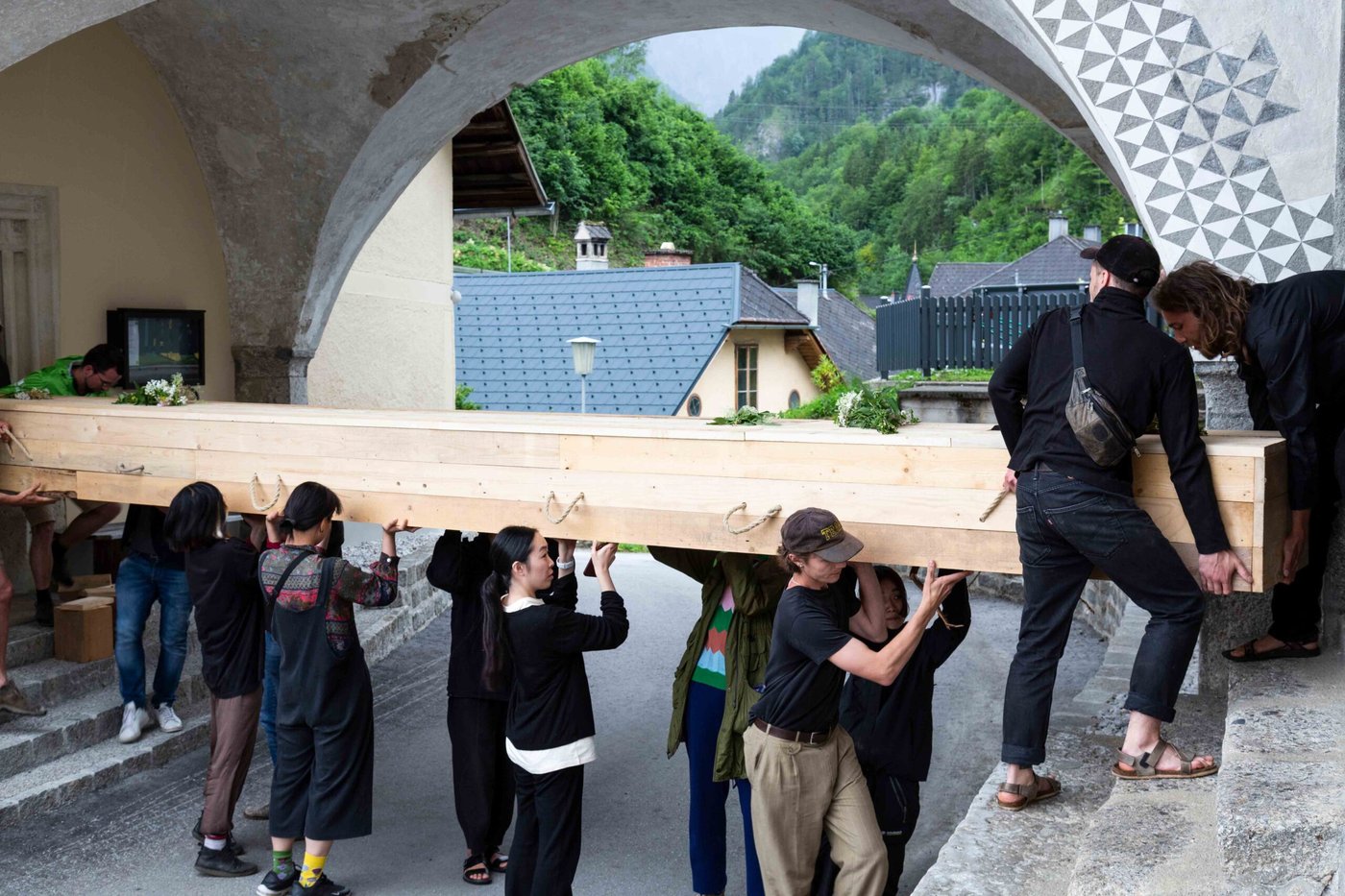 People carrying a huge wooden coffin