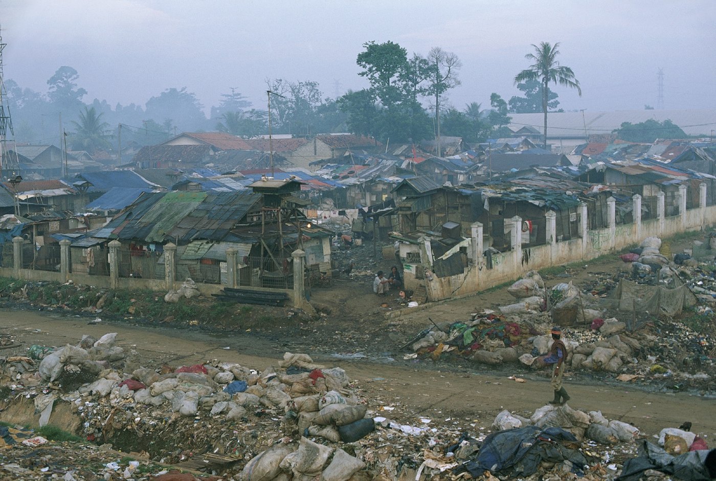 a few huts and a lot of garbage on a colored photograph