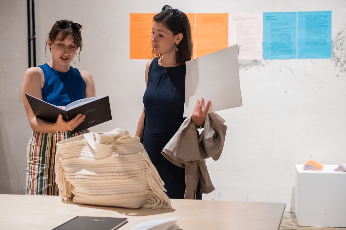 Two persons looking at a thesis