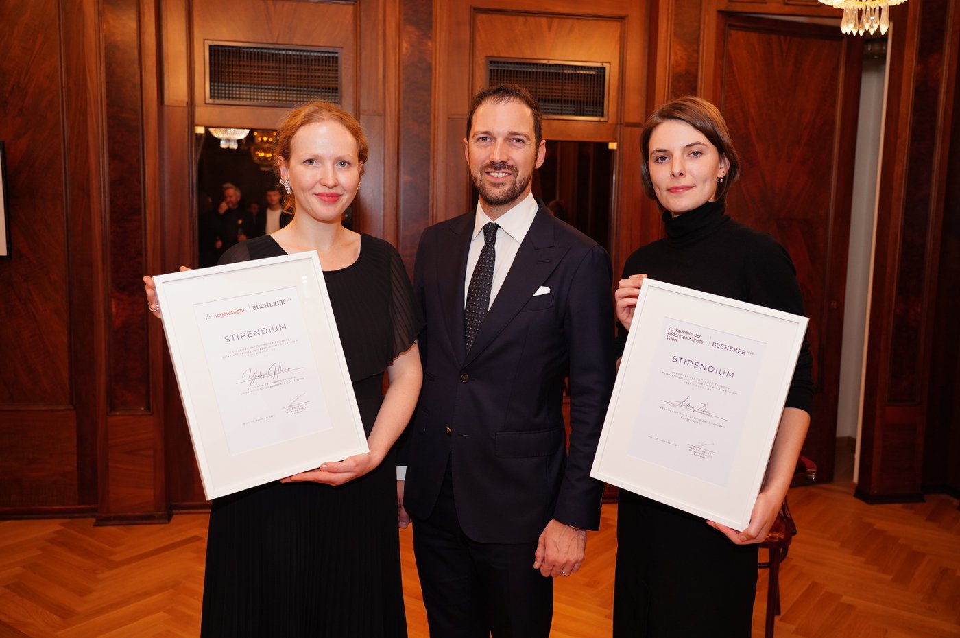 Picture of three people with awards in their hands