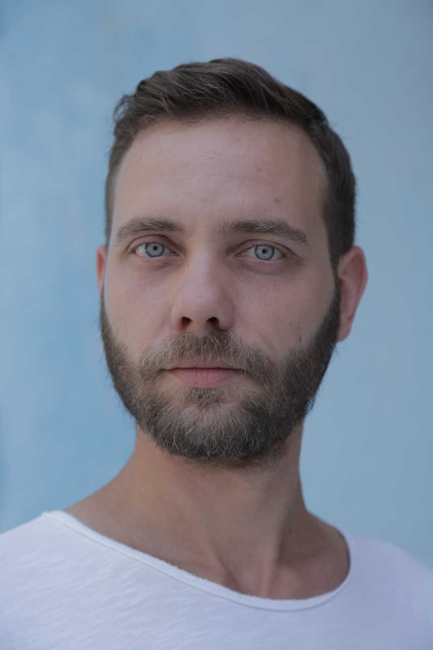 David Cuka, A young Albanian man, photographed after COVID on the streets of Tirana for the project 999 Portraits of Albanians during 2021.